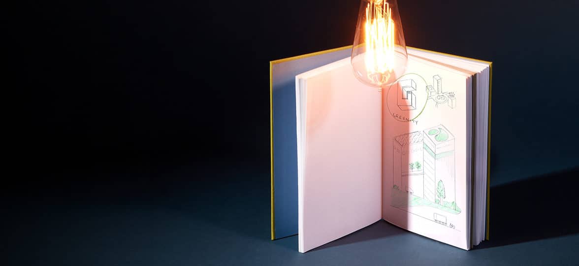 MOO Hardcover Notebook open to a page with doodles and notes under a lit light bulb for Innovation Day