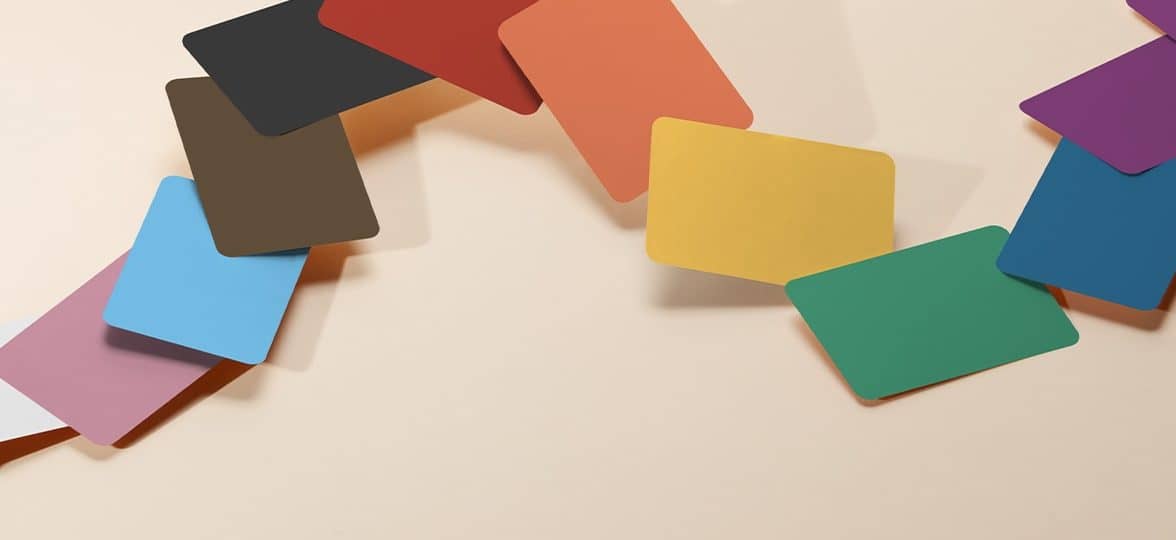 Collection of business cards arranged like a color fan, each card in a different color to evoke the rainbow flag and with a different color thanks to Printfinity