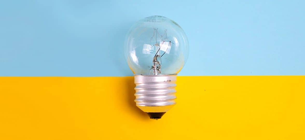 Light bulb on a yellow and blue background