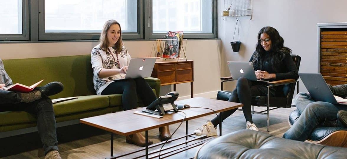 4 people on their laptop in a meeting room