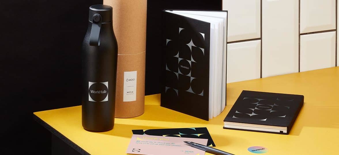 Black water bottle, custom notebooks and print products