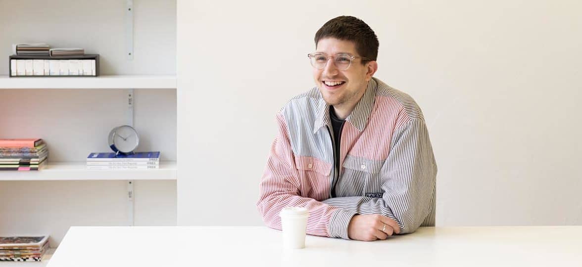 MOO's lead designer Phil Bailey at a desk in the MOO office