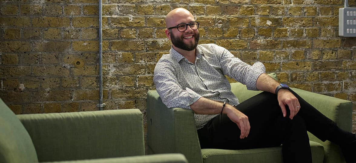 Portrait of Federico Franceschetti, senior software engineer at MOO, on a sofa