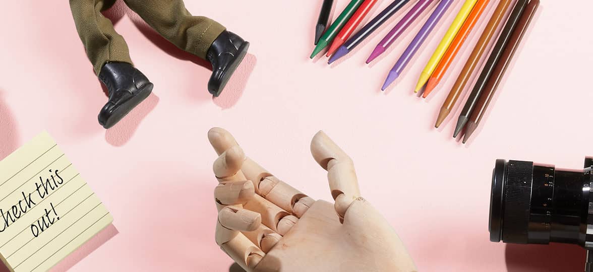 Toys and pencils on a pink table