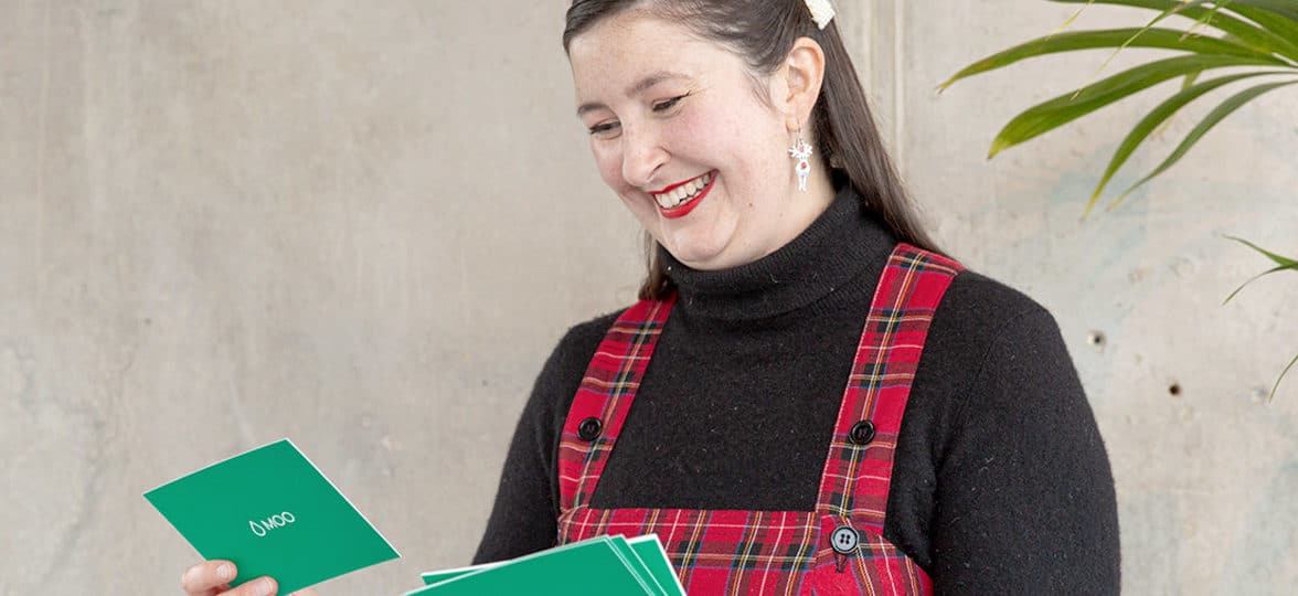 Office manager Zoe smiling at question cards