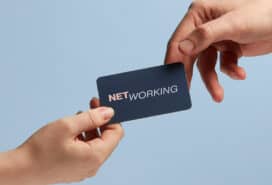 Networking with a business card being handed to a potential client