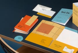 Custom folder, brochure, postcard, bookmark and notecard displayed on table.