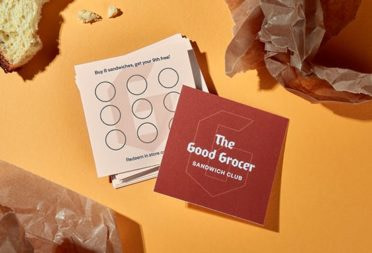 Square loyalty cards on an orange background