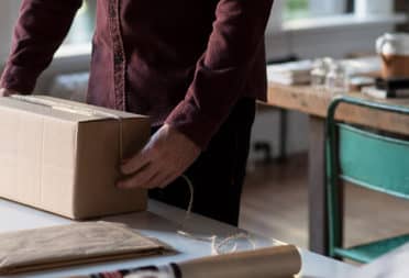 Person preparing parcels to send in a studio