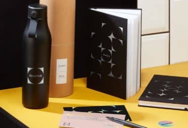 Black water bottle, custom notebooks and print products