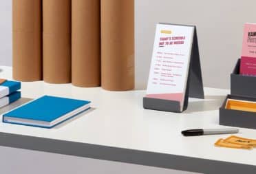 Table with display boxes and various print products