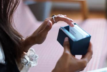 Shannen looking through a box of business cards in durable paper