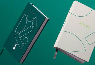 2 custom notebooks with green cover and grey cover