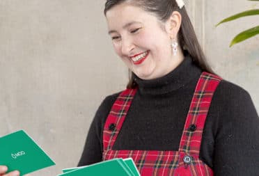 Office manager Zoe smiling at question cards