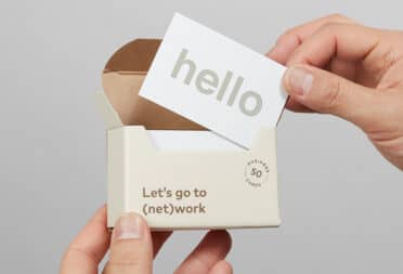 Business Cards with 'Hello' written on, in sustainable packaging from MOO