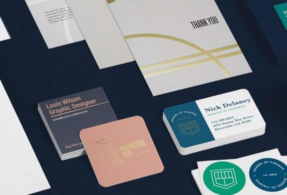 Set of print materials including flyers, postcards, business cards, and stickers