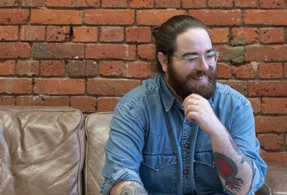 Barry Murphy sitting on the couch at MOO and smiling