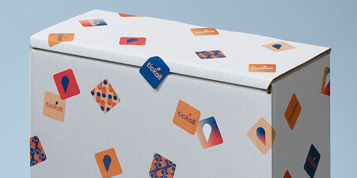 Small square stickers in various designs on a box