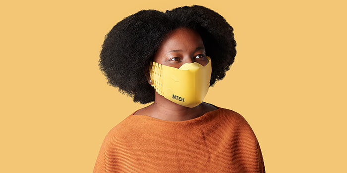 Woman wearing a yellow custom paper face mask by MOO