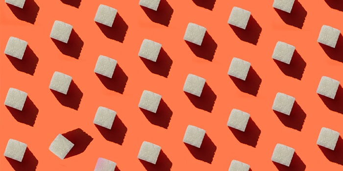 White cubes on an orange background, with all the cubes in the same position except one