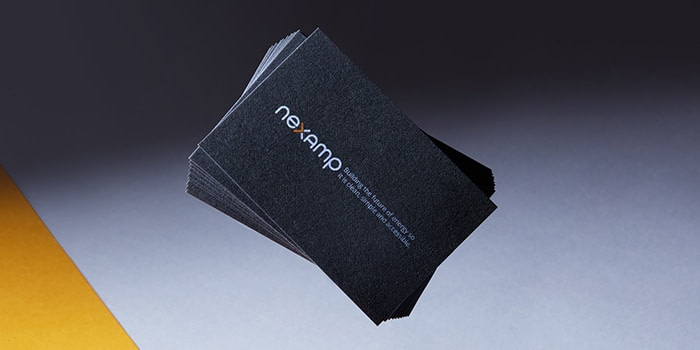 Stack of Nexamp business cards made on recycled cotton