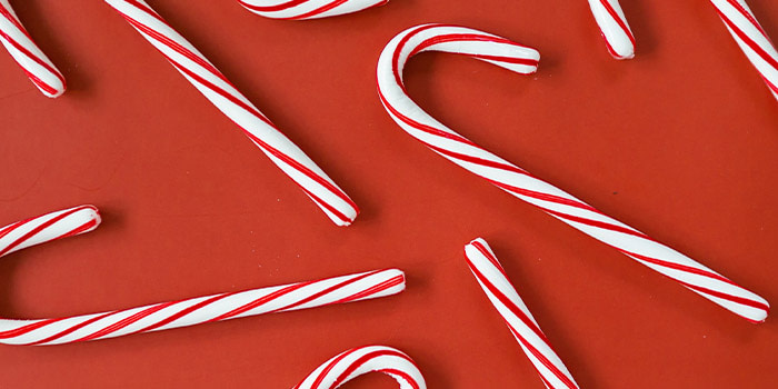 Striped candy canes on a red background