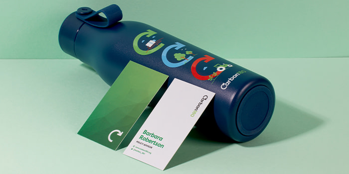 Custom blue water bottle and two business cards by Carbon180