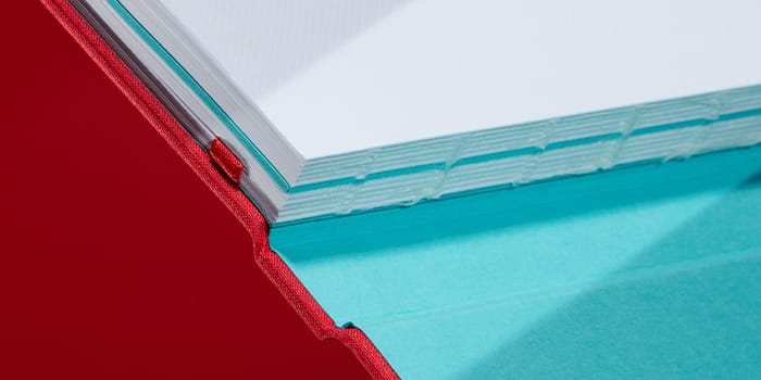 Red hardback journal with cloth cover and swiss binding