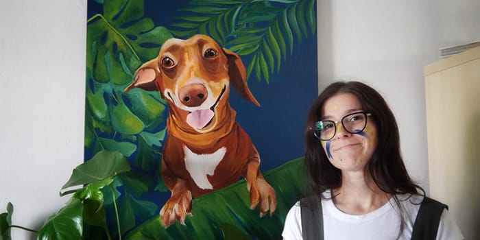 Artist Patricia Patto Galbani in front on a painting of her dog
