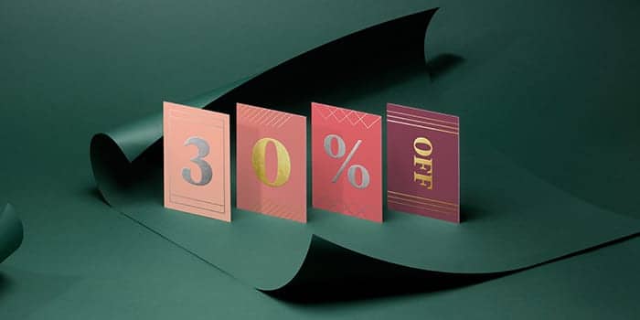 4 business cards with gold and silver foil finish spelling 30% off
