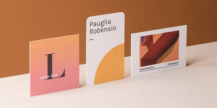 3 cotton business cards in various formats and designs on an orange background