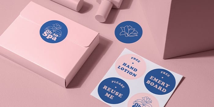 Blue and pink round stickers on a pink background