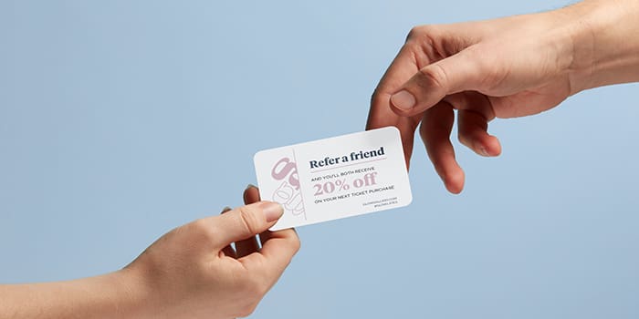 Hand presenting a referral card