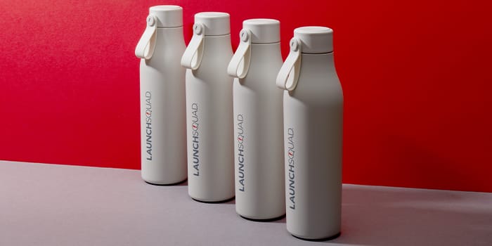 4 grey water bottles with a custom logo design by LaunchSquad and MOO