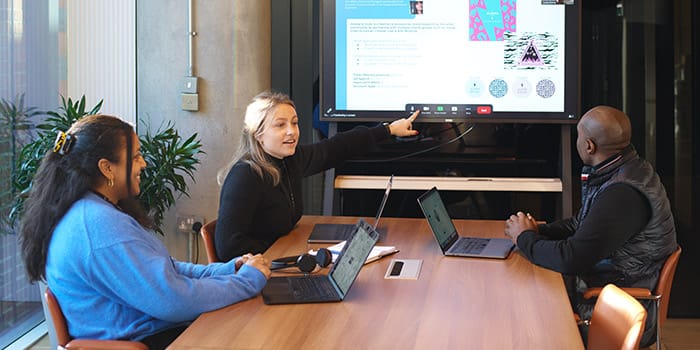 Members of the sales team in a meeting in a conference room