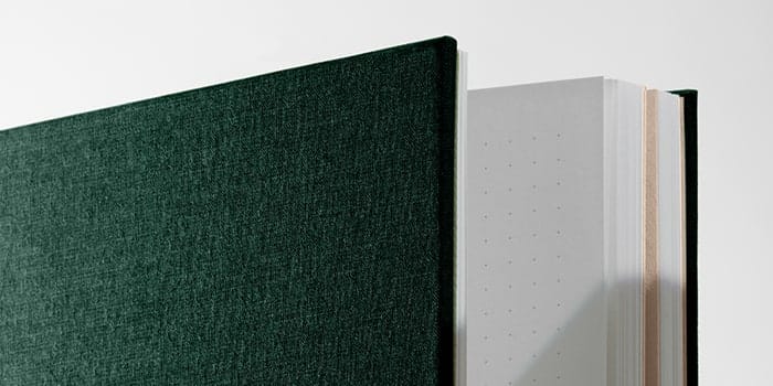 Closeup of a green dotted journal