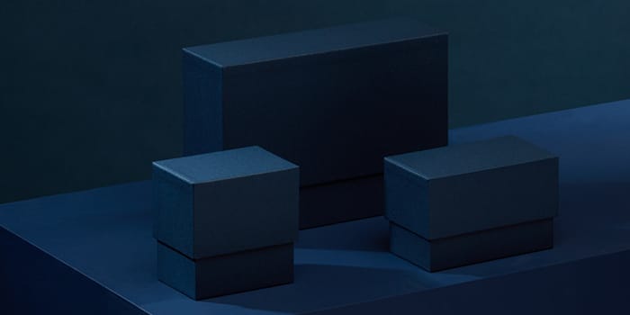 Three navy blue display boxes for business cards and postcards