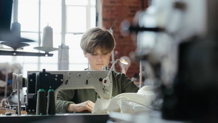 Person making clothes with sewing machine
