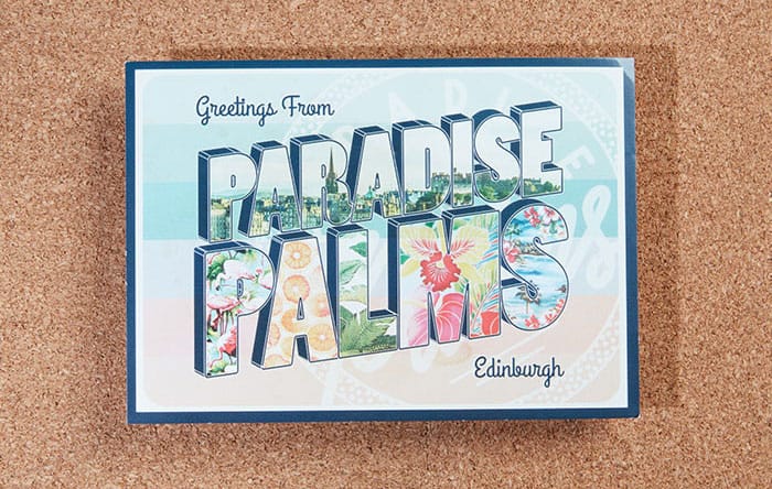 Paradise Palms postcard on a cork board