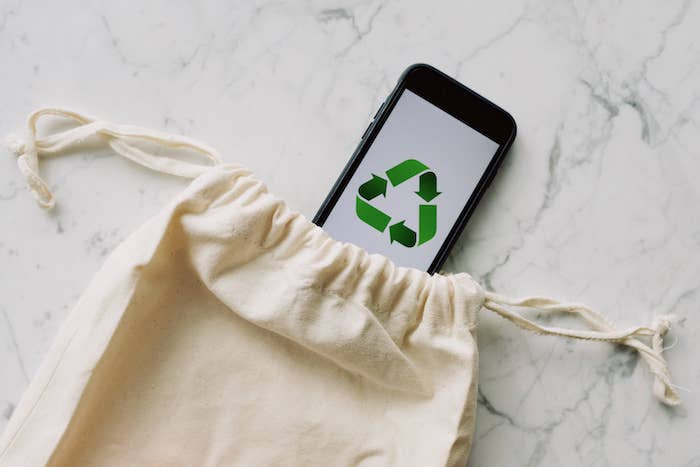 Fabric bag and phone with the recycling symbol