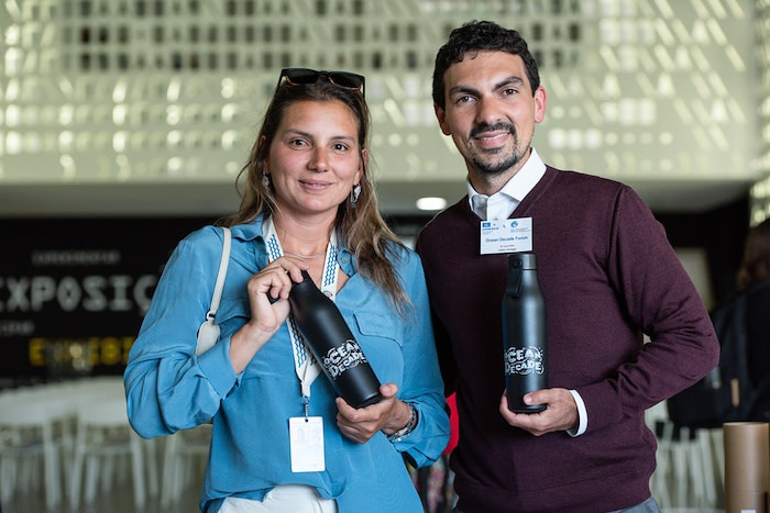 Maya Gabeira and Vinicius Lindoso with custom MOO water bottles at the Ocean Decade