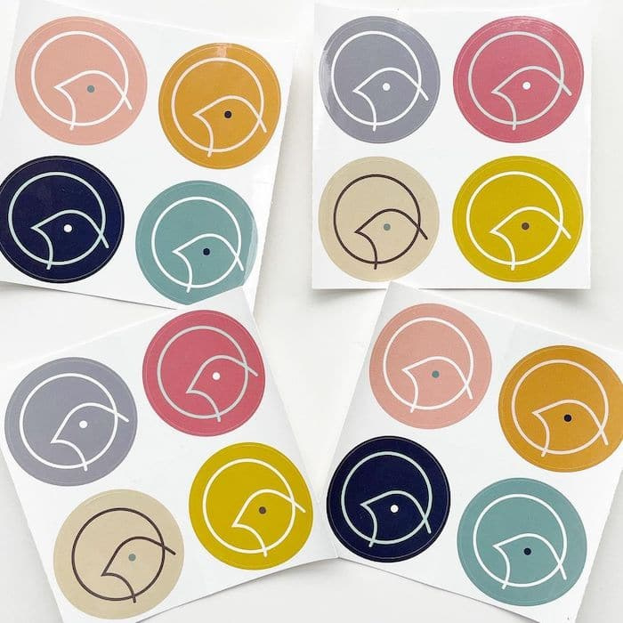 4 sheets of 4 round stickers in various colors with a bird logo by Lark party