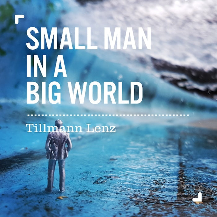 Photography business card design with small figurine in a blue landscape photographed by Tillmann Lenz for his small man in a big world series