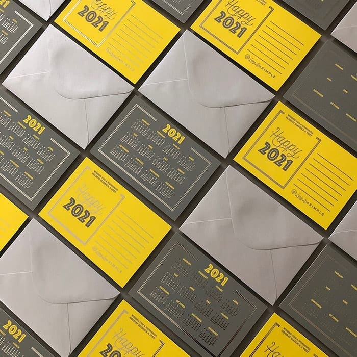 Mosaic of silver envelopes, and yellow and grey calendar postcards