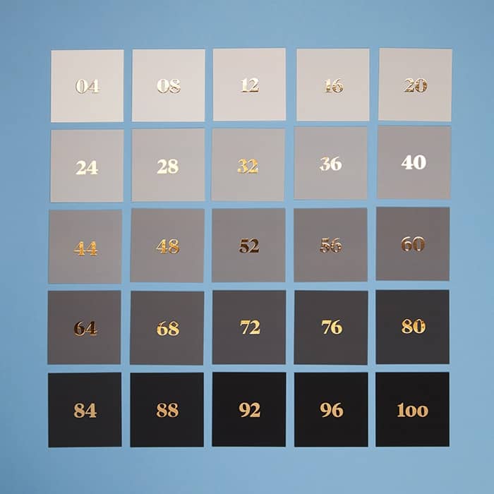 25 square business cards with a gradient from white to dark grey with foil numbers