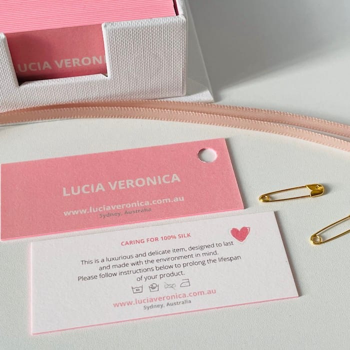 MOO MiniCards with pink edge used as mini clothing swing tags by lingerie brand Lucia Veronica