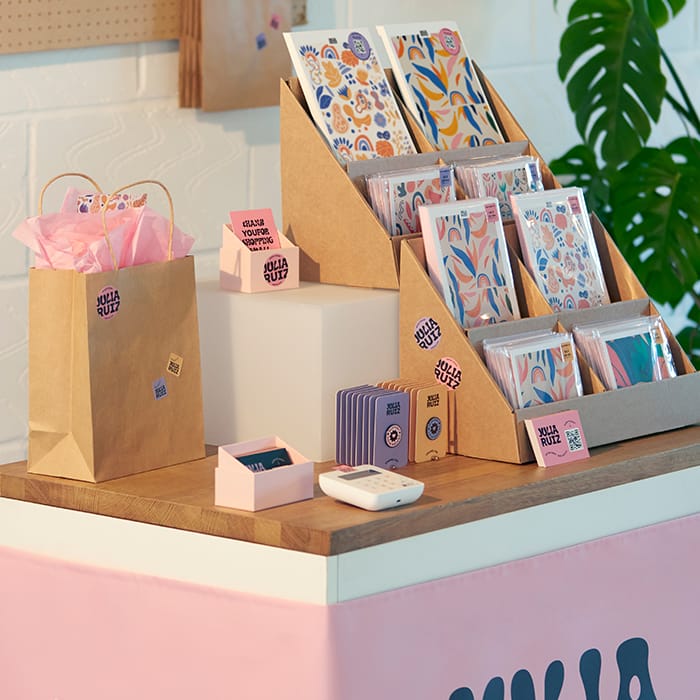 A colourful display of print products with Flyers, Stickers and merchandise.