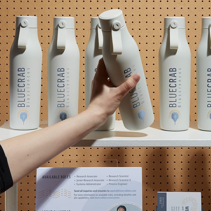 A selection of branded waterbottles displayed on a trade show stand 